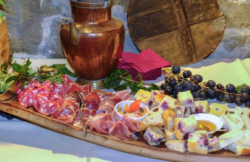 a tray of food with meat and vegetables on a table at Locanda Del Molino in Cortona