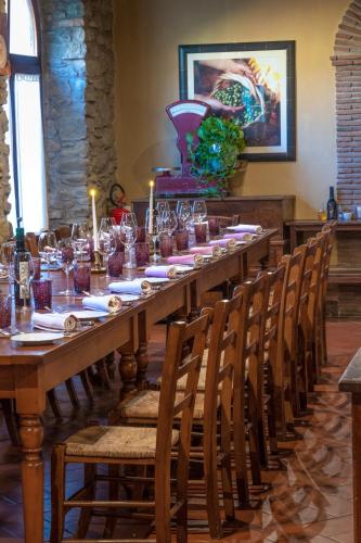 a long table with glasses and candles on it at Locanda Del Molino in Cortona