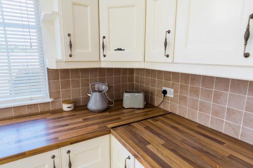 a kitchen with white cabinets and a blender on a counter at Dublin Airport Homestay in Dublin