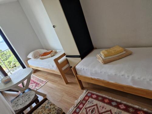 Kleines Zimmer mit 2 Betten und einem Tisch in der Unterkunft Ferienhaus in Klenovica mit Garten, gemeinsamem Pool und Terrasse und Panoramablick in Klenovica