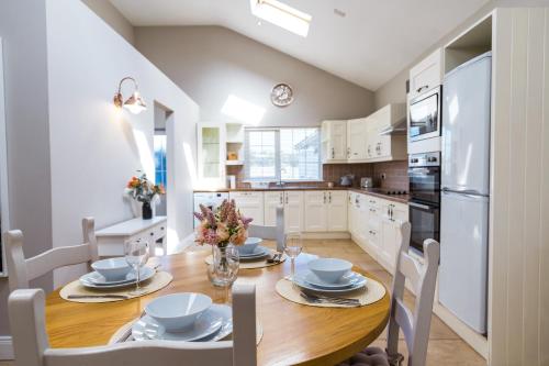a kitchen with a wooden table with chairs and appliances at Dublin Airport Homestay in Dublin