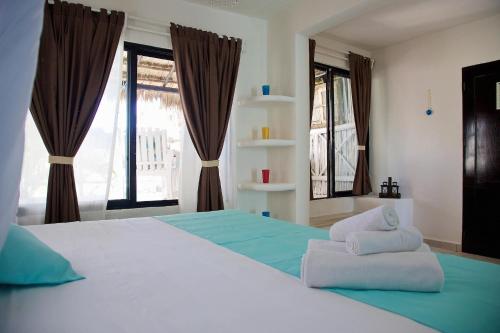 Ένα ή περισσότερα κρεβάτια σε δωμάτιο στο Punta Piedra Beach Posada