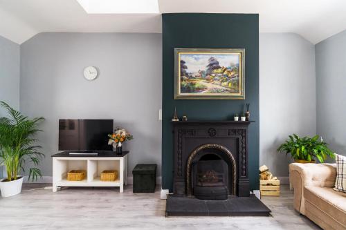 a living room with a fireplace and a tv at Dublin Airport Homestay in Dublin