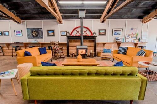 a living room with a green couch and a fireplace at Evergreen in Waldport