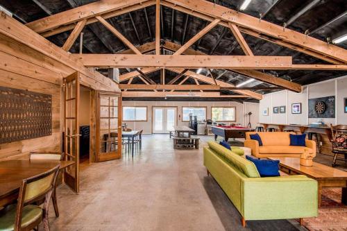a large living room with wooden ceilings and furniture at Evergreen in Waldport