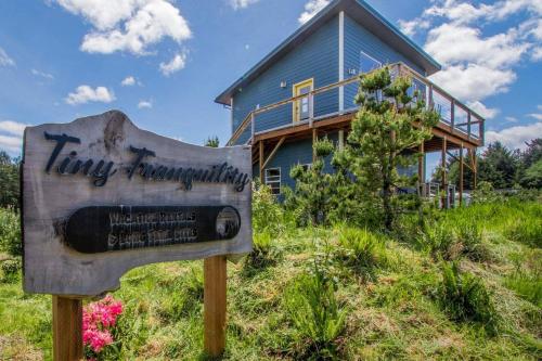 a sign in front of a blue house at Evergreen in Waldport