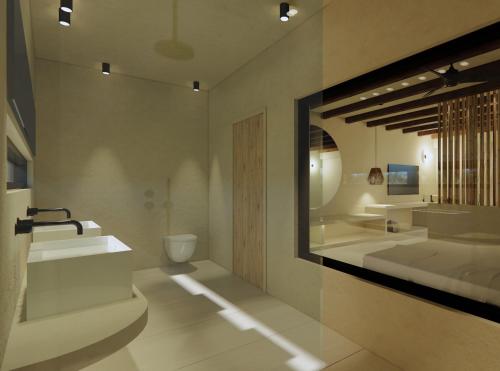 a bathroom with two sinks and a toilet at ARC suites in Ios Chora