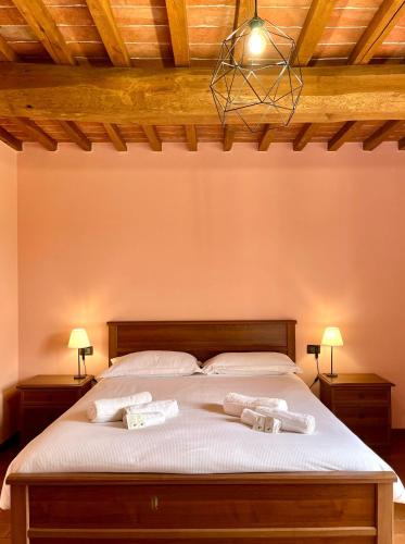 a bedroom with a bed with two towels on it at Sibolla Holidays in Altopascio