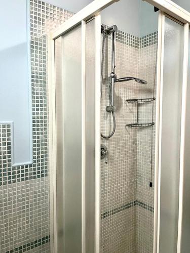 a shower with a glass door in a bathroom at Sibolla Holidays in Altopascio