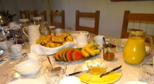 a table with a plate of food and fruit on it at Chez Providence Chambres et Table d'Hôtes in Cuxac-Cabardès