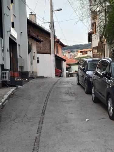 two cars parked on the side of a street at Himber Rooms in Sarajevo