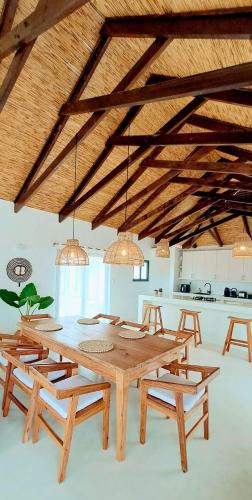 a large wooden table and chairs in a kitchen at Coral Villa - Beachfront Villa with Private Pool by Karula in Inhambane