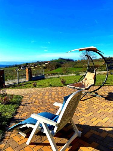 a white rocking chair sitting on a brick patio at I 4 bimbi in Borgomale