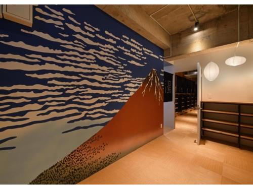 a wall mural of the ocean in a room at Santiago Guesthouse Naha - Vacation STAY 86300v in Naha