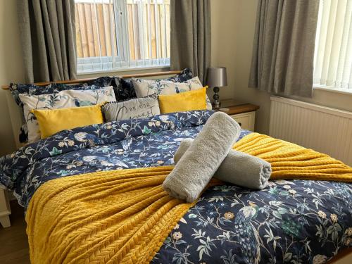 a bed with a stuffed animal on top of it at Fabulous Bungalow Norwich in Norwich