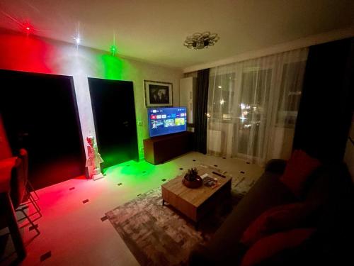 a living room with a television and a green light at Fortress View in Râşnov