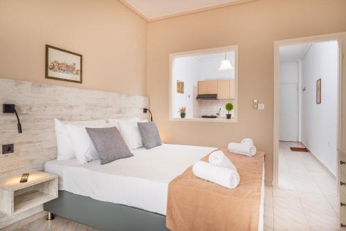 a bedroom with a large white bed in a room at City Life Marina apartment No. 5 in Ampavris