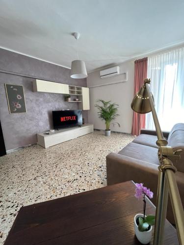 ein Wohnzimmer mit einem Bett und einem TV in der Unterkunft Luna Apartment in Civitavecchia