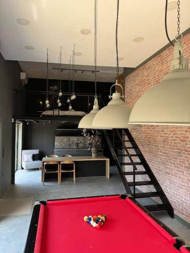 a red pool table in a living room at The Loft. Gerakas. in Athens