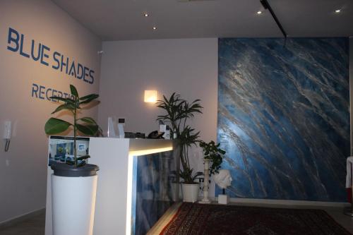 a room with a large painting of a blue shark on the wall at Blue Shades Hotel in Pisa