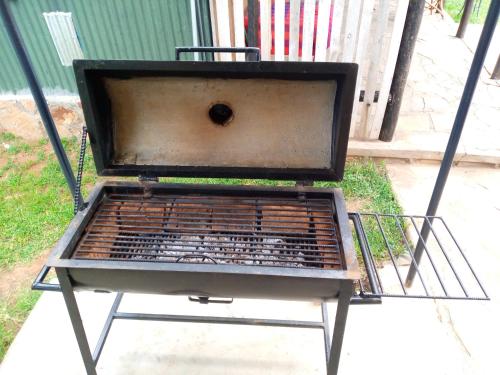 a large grill sitting on the side of a sidewalk at Esam Homestay in Sekenani