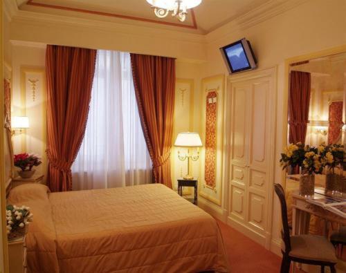 a hotel room with a bed and a window at Hotel Champagne Palace in Rome