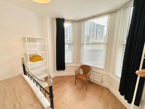 - une chambre avec un lit, une chaise et des fenêtres dans l'établissement Luxury 1 bed Apartment, à Portadown