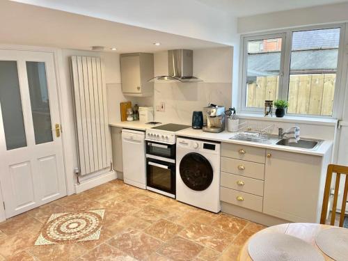 a kitchen with a stove and a dishwasher at Luxury 1 bed Apartment in Portadown