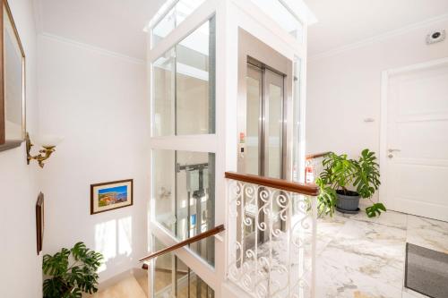 a glass staircase in a home with potted plants at Ta' Dun Martin and taz-Zija Bed and Breakfast in Nadur