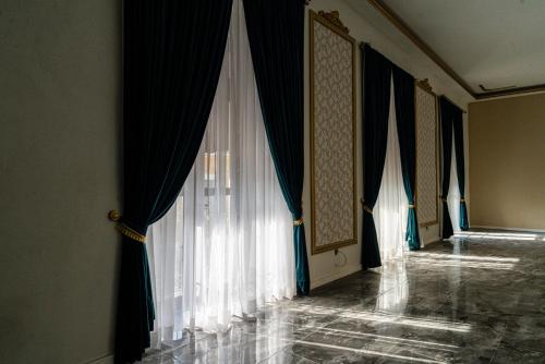 a room with white curtains on the wall and a room with at HOTEL BOUTIQUE CASONA 65 in Puebla