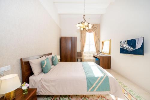 a bedroom with a bed and a table and a window at Ta' Dun Martin and taz-Zija Bed and Breakfast in Nadur