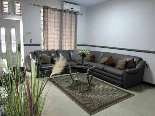 a living room with a couch and a table at Luxurious house in Paramaribo, Zorg en Hoop in Paramaribo