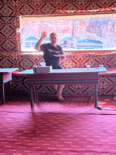 a man sitting at a ping pong table at Mars moon camp in Wadi Rum