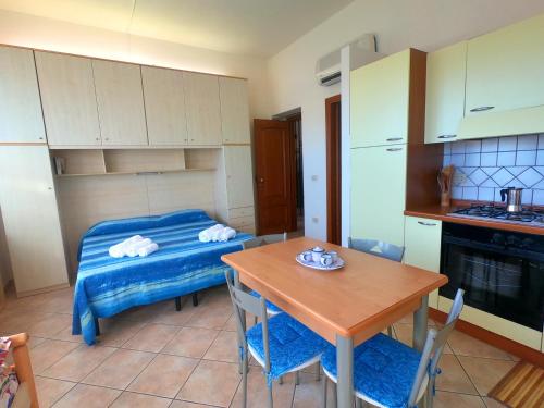 a kitchen with a table and a small table and a table and a table at Villa Emilia appartments in Cala Gonone