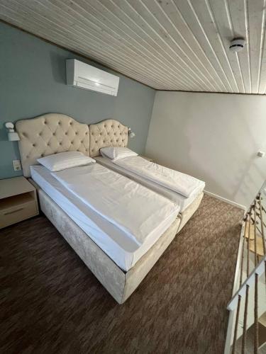 a bedroom with a large bed in a room at Pensiunea Ancuței in Şerpeni