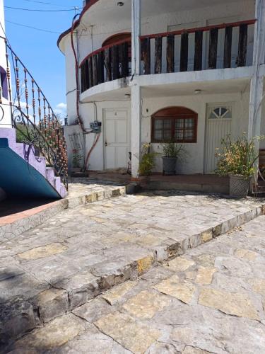 a house with a staircase leading up to it at Rincón San Jerónimo in Tamasopo