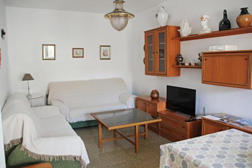 a living room with a couch and a tv at Duplex Antonio Machado in Carboneras