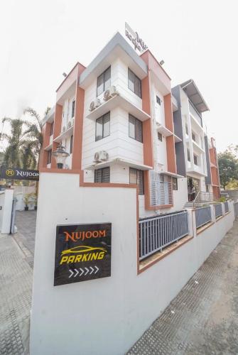 a building with a sign on the side of it at Nujoom Apartments in Ernakulam