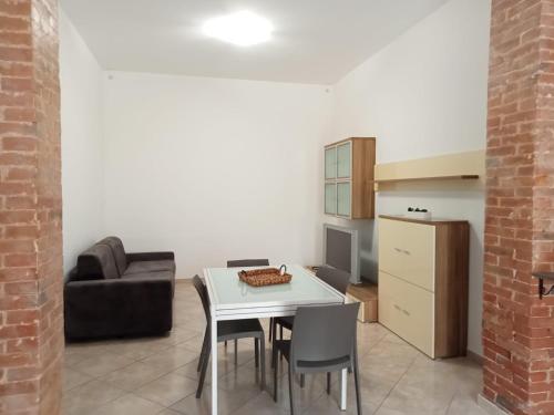 a kitchen and dining room with a white table and chairs at La Rizzaia casa indipendente in Trapani