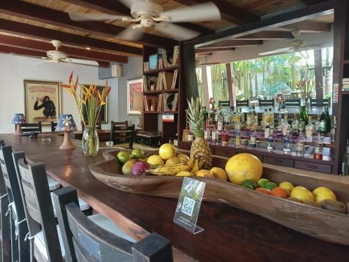 a bar with a bowl of fruit on a table at Monkey Casa Hotel in Trancoso