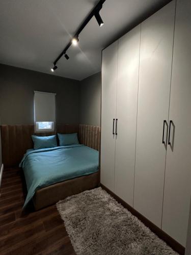 una camera con letto, armadio e tappeto di Amazon House 8 a Tirana