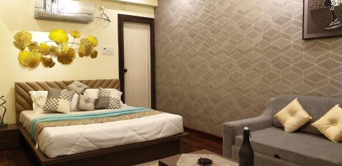 a bedroom with a bed and a couch at PANTHASHALA Dooars in Lataguri