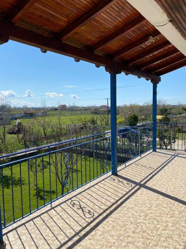 a balcony with a fence and a view of a field at Bert-House close to the sea in Lezhë