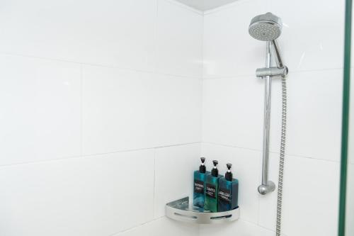 a shower in a bathroom with bottles on a counter at SurfersResidence Apartments in Tarifa