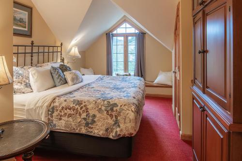 a bedroom with a large bed and a window at The Ridgeway Inn in Blowing Rock