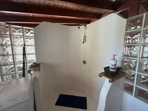 a kitchen with white walls and windows and a sink at Loft near the BEACH in La Mareta