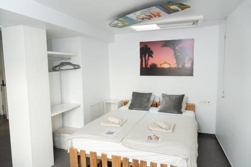 a bedroom with a bed in a white room at SurfersResidence Apartments in Tarifa