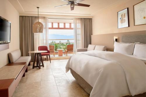 a hotel room with a bed and a living room at The Westin Resort & Spa, Puerto Vallarta in Puerto Vallarta