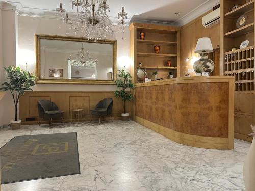 a salon with a mirror and a reception desk at Hotel La Pace in Pontedera