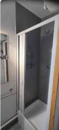 une salle de bain avec douche et miroir dans l'établissement Studio a la mer piscine wifi parking clim, à La Grande Motte